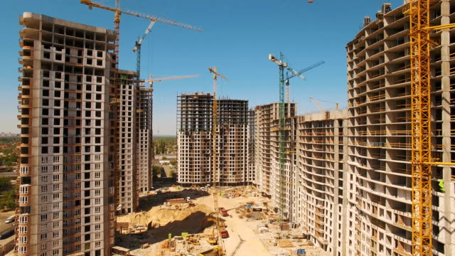 Construction-of-houses.-Drone-fly-over-construction-site-with-tower-cranes
