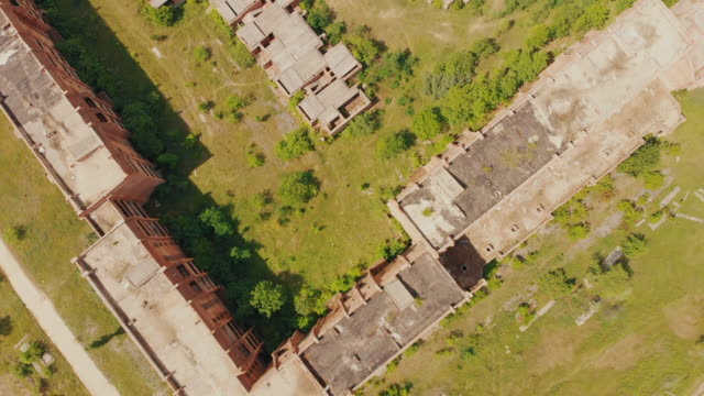 Flying-above-old-abandoned-construction.-AERIAL:-Flight-over-unfinished-high-rise-building-with-apartments.-Drone-view.-Summer-season.-Abandoned-city-after-disaster.-HD-footage