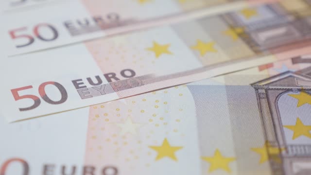 Lot-of-fifty-Euro-banknotes-in-a-row-money-background-slow-tilt-4K-3840X2160-UHD-footage---European-Union-currency-50-Euro-denominations-4K-2160p-UltrahD-tilting-video