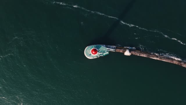 Aerial-top-view-of-white-lighthouse-near-sea-port