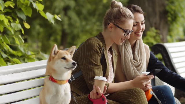 Two-Female-Friends-with-Their-Doggies-Outdoors