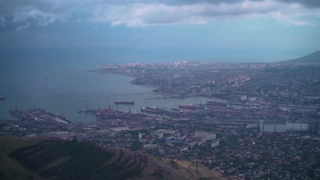 Footage-of-the-city-with-a-bay,-port,-buildings,-mountains.-Ariel-view-of-Novorossiysk.-Russia.