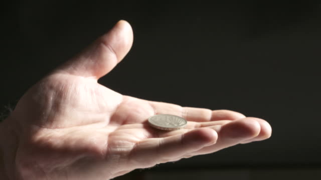 Hand-palm-up-holding-silver-Deutsche-Mark-coin.