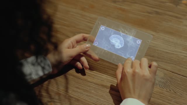 Hands-hold-tablet-with-human-brain
