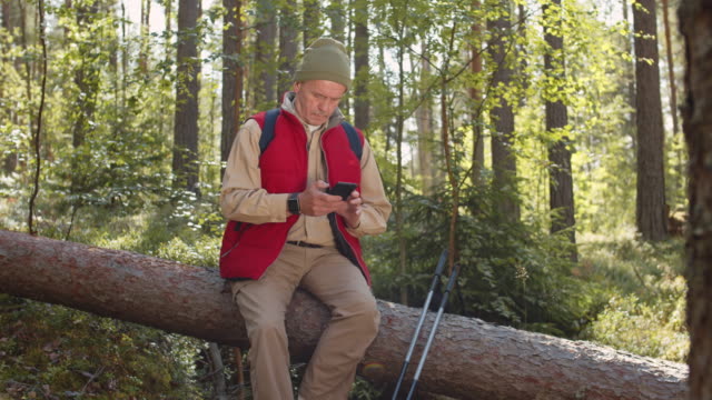 Retired-Sportsman-Using-Cellphone-in-Woods