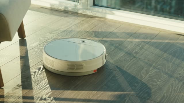 Close-up-of-the-robotic-vacuum-cleaner-riding-around-and-cleaning-up-apartments