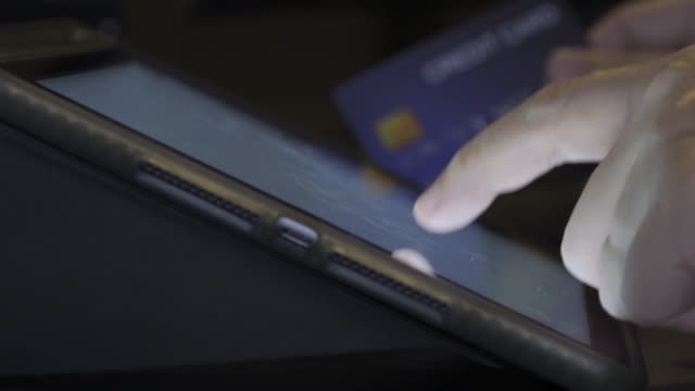 4K-Video-finger-touch-on-tablet-screen-with-credit-card.