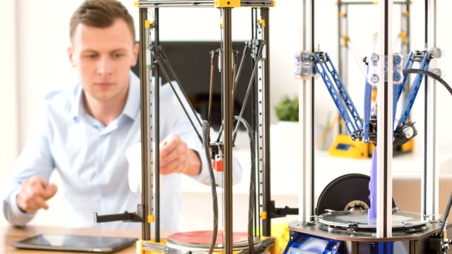 Serious-man-working-with-3d-printer