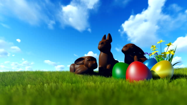 Easter-Eggs-and-Chocolate-Bunnies-on-green-meadow-against-blue-sky