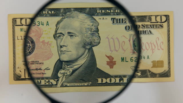 Approaching-using-a-magnifying-glass-ten-dollar-bill