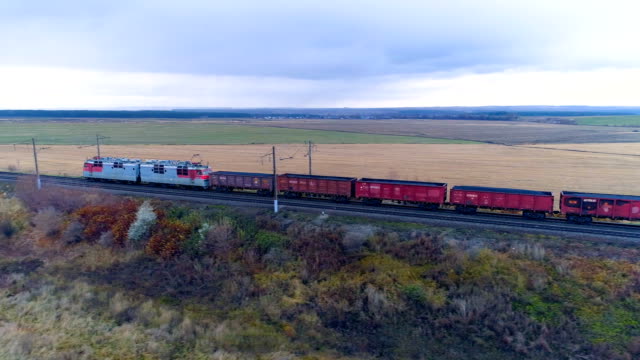 A-freight-train-moves-away-along-an-embanked-track.
