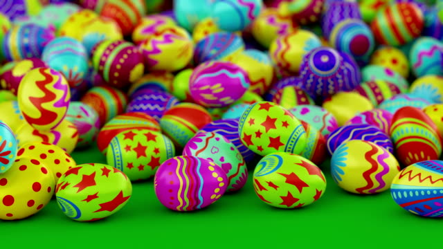 Colorful-Easter-eggs,-fall-into-the-frame-and-fill-it-completely.-Green-background.