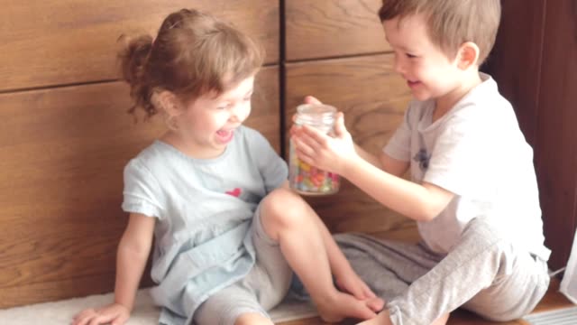 cute-kids-playing-with-jar-of-candies