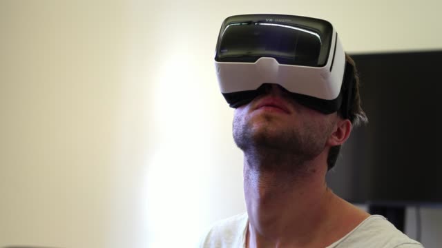 young-white-male-Virtual-Reality-Engineer/-Developer-Wearing-VR-Headset.