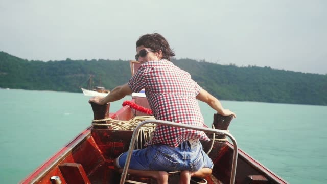 Happy-attractive-man-in-sunglasses-enjoying-sailing-boat-on-sea,-slow-motion.-1920x1080