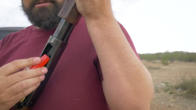 Handsome-Bearded-Man-Loading-Ammo-Shells-into-a-Shotgun-in-Slow-Motion