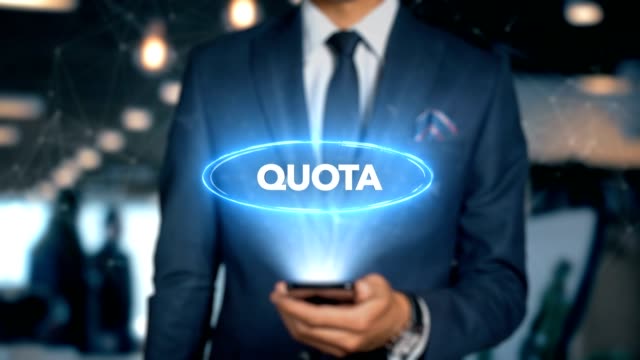Businessman-With-Mobile-Phone-Opens-Hologram-HUD-Interface-and-Touches-Word---QUOTA