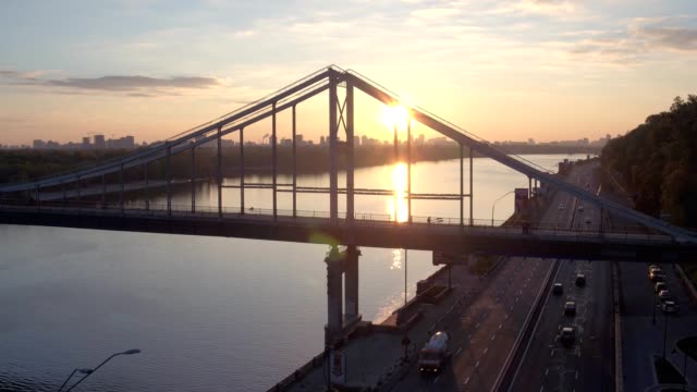 Aerial-shooting-pedestrian-bridge-of-Kiev-on-sunrise.-Summer-morning-in-Kiev-Dniepeer-river.-Ukraine.-European-city