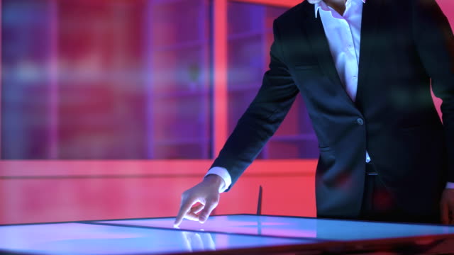 The-businessman-working-with-a-sensor-display-on-a-hologram-background