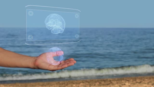 Manos-masculinas-en-la-playa-con-cerebro-holograma