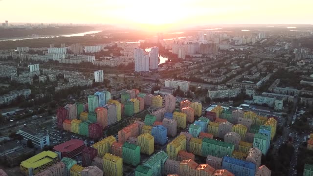 Colorful-buildings-of-a-residential-district,-aerial-shot-from-a-drone-at-sunset-over-Comfort-Town.-Kiev,-Ukraine