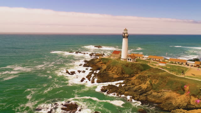 Light-House-Drone-Shot-aerial-Helicopter-view-ocean-coast-line-with-crashing-waves-sun-set-4K