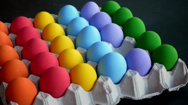 Hands-picking-up-colorful-eggs