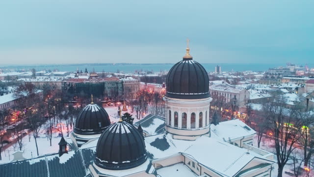 Cinematic-aerial-view-of-dome-and-orthodox-cross-on-spire-of-Transfiguration-Cathedral-in-Odessa-on-winter-evening.