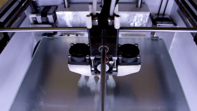 Three-dimensional-printer-during-work-in-laboratory,-3D-plastic-printer,-3D-printing