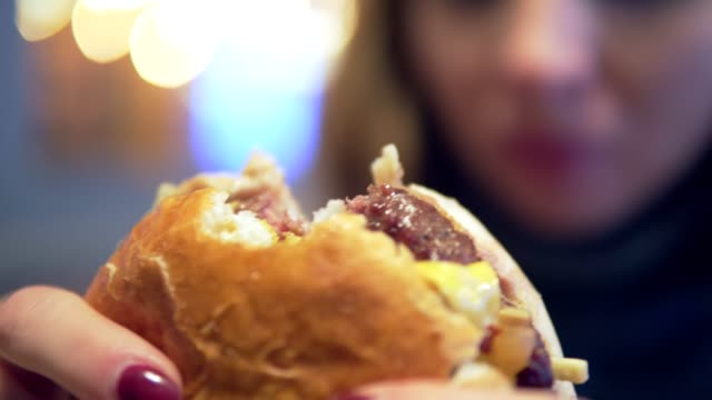 Woman-in-cafe-eating-hamburger