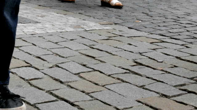 Lot-of-feet-a-crowd-of-people-strolling-along-the-cobbles-of-the-city