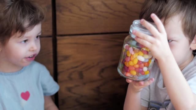 children-watching-a-candy-jar