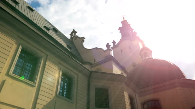 Sun-rays-lighting-up-beautiful-church-building-in-Lviv,-praying-place,-blessing