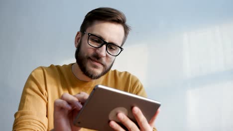 Trendige-Mann-nutzt-Tablet-Computer-für-die-Kommunikation