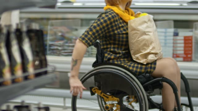 Paraplegic-Woman-Riding-Wheelchair-in-Supermarket