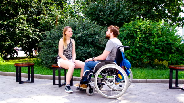 Young-disable-man-with-his-wife-sitting-in-the-park