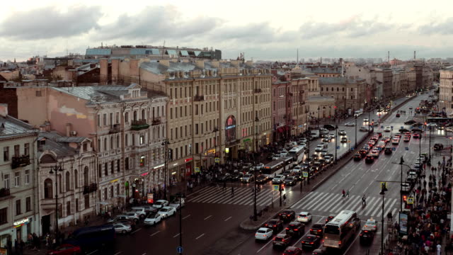 People-and-cars-moving-along-prospect-in-Saint-Petersburg-at-evening
