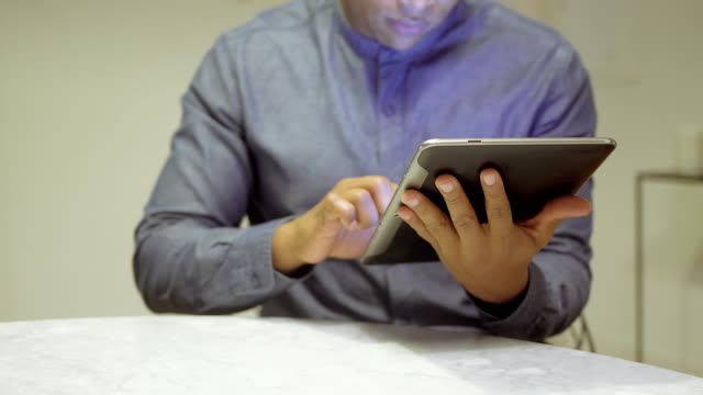 African-american-young-man-using-tablet.