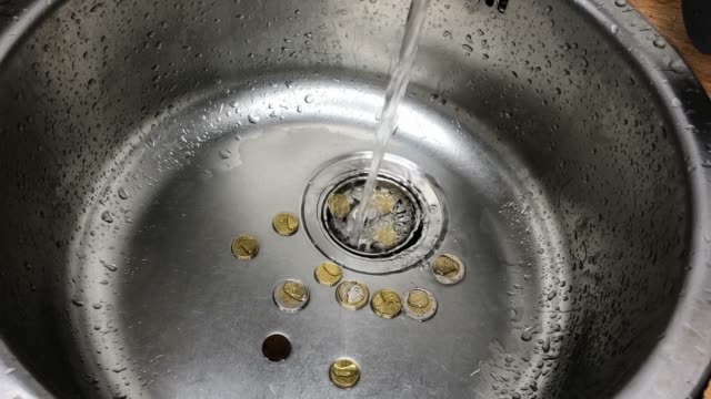 Money-laundering-concept,-washing-coins