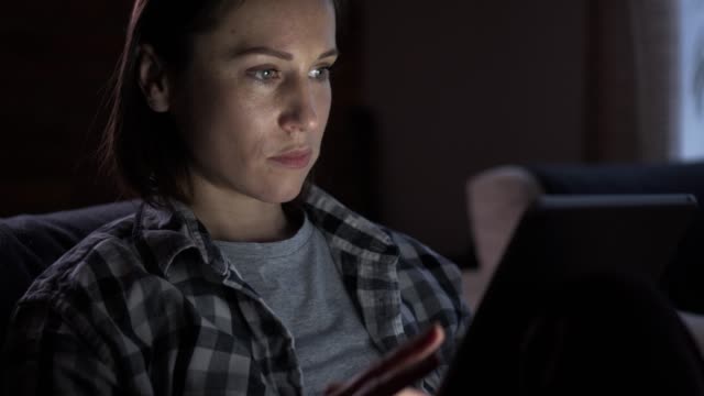 Woman-using-digital-tablet-at-night