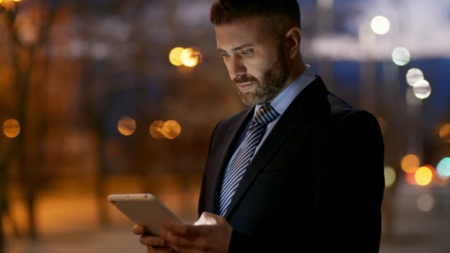 Businessman-with-Tablet-at-Night