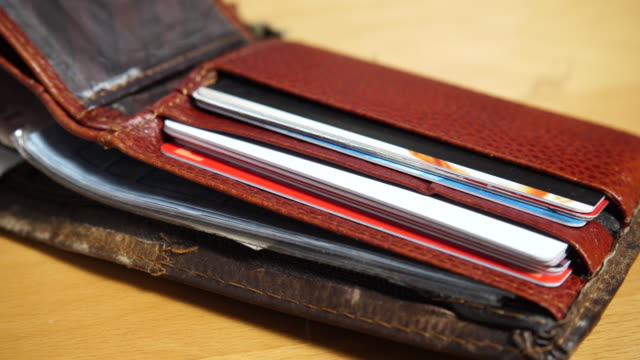 Open-leather-brown-wallet-with-credit-and-discount-cards-4K