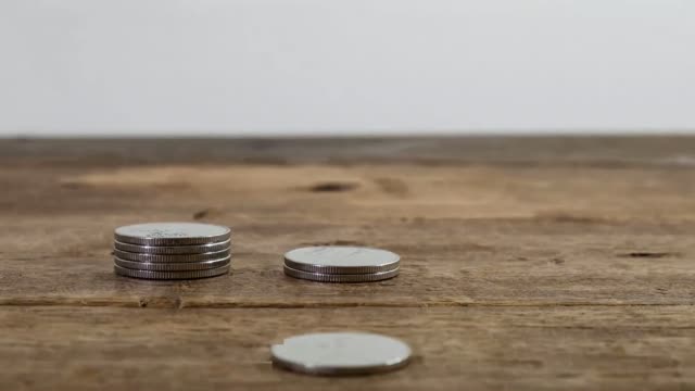 stop-motion-animation-video-footage-of-increasing-coins-stacking-piles