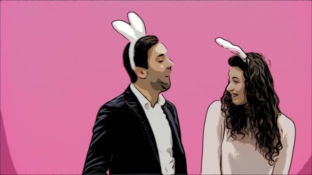 Young-beautiful-couple-standing-on-a-pink-background.-During-this,-they-are-dressed-in-rabble-ears.-Looking-gently-at-each-other,-in-love.-Easter-concept.-Animations.