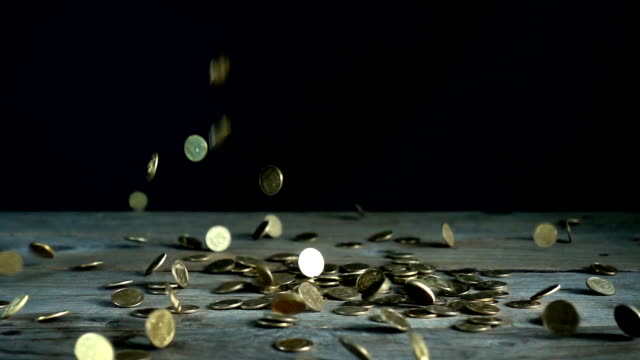 Slow-motion,-a-pile-of-Ukrainian-coins-falls