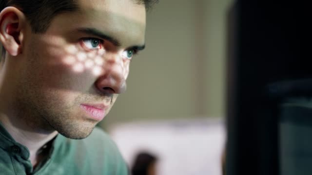 Closeup-of-concentrated-young-technician-carefully-observing-work-of-3d-printing-machine-in-laboratory