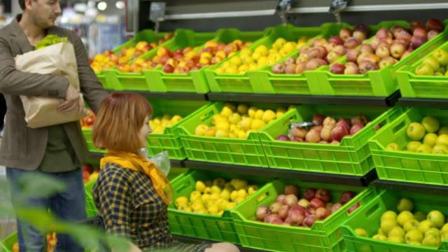 Woman-on-Wheelchair-Shopping-with-Husband-in-Produce-Department
