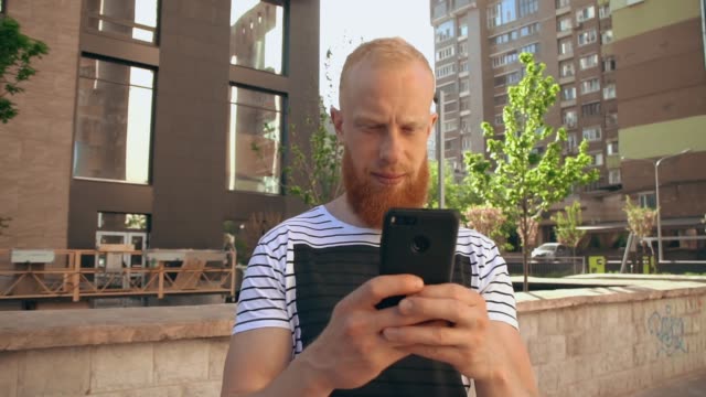 ginger-guy-scrolling-touch-screen-phone