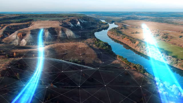 4k-Aerial-view-The-concept-of-disseminating-information,-data-flows-over-a-natural-landscape-with-a-river-and-mountains