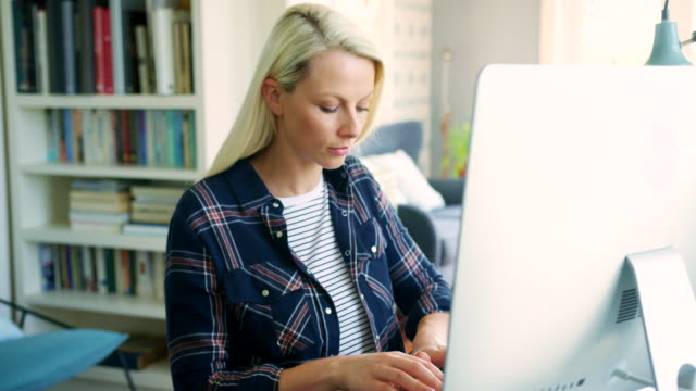 Beautiful-Blond-Businesswoman-Typing-On-Computer-At-Home-Office